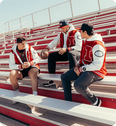 Three men are wearing Varsity jackets